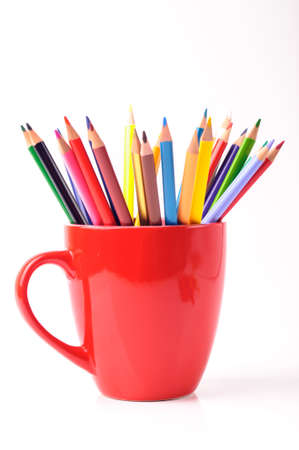 A red cup with color pencils in itの写真素材