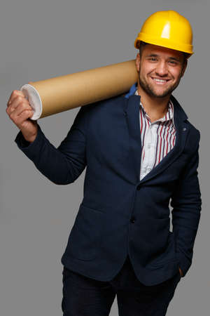 Man in a hard hat with a storage tube