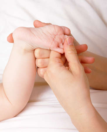 A little foot of a baby being held by her motherの写真素材