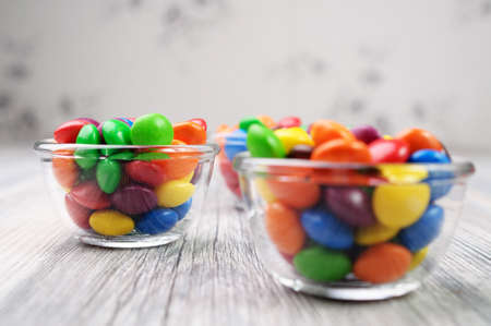 Multicolored candies in transparent bowlsの写真素材