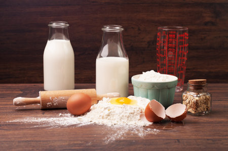 A measuring glass, bottles of milk and other ingredients