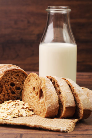 A sliced homemade bread and a bottle of milk