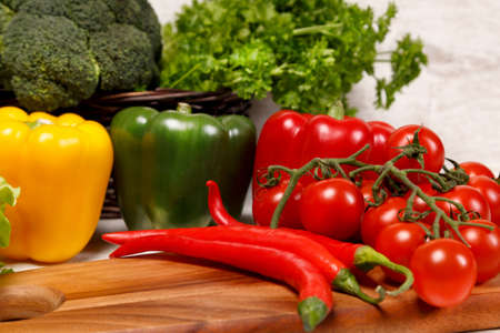 Tomatoes and pepper on a wooden boardの写真素材