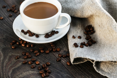 A cup of morning coffee on a wooden background