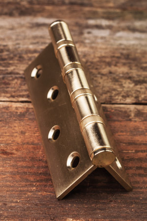 Metal hinge on a wooden surface