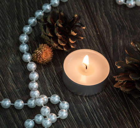 Pine cones and a single little candleの写真素材