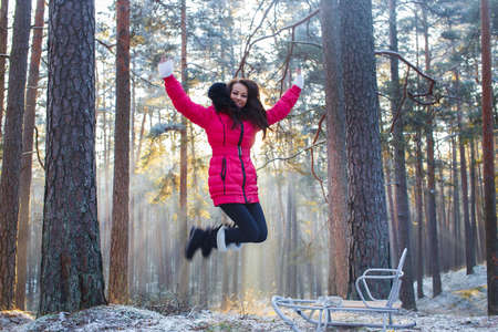 girl jumping in the winter forestの写真素材