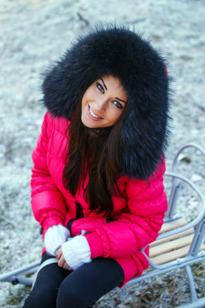 girl sitting on the sledge and posingの写真素材