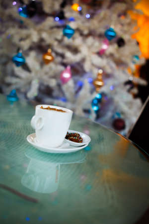Photo of  white cup with tasty coffee, Christmastime table setting.Christmas mood.の写真素材