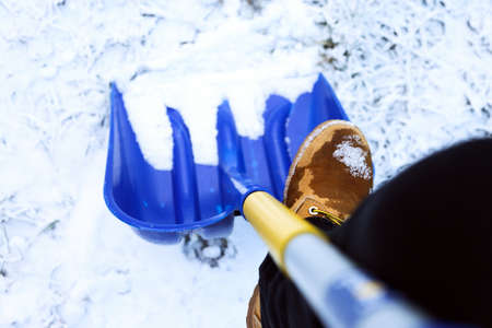 Man worker in uniform ,shoveling snowの写真素材