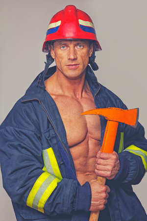 Portrait of muscle man posing in studio with hummelの写真素材