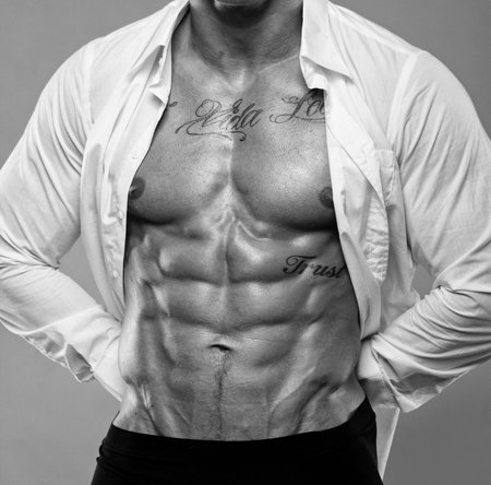 Portrait of muscle man torso on grey backgroundの写真素材