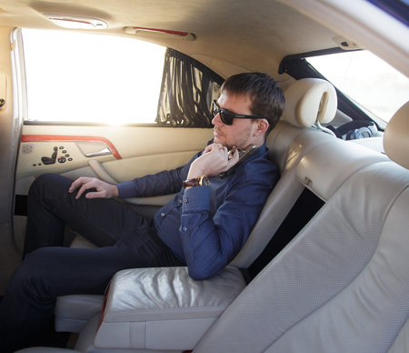 Rich gangster is sitting in his luxury car