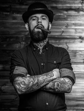 Portrait of brutal tattooed male smoking cigarの写真素材