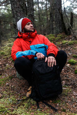 Hiker have short respite on his way in the forestの写真素材