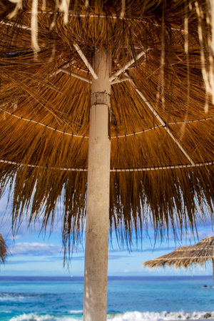 Sunshade on the beach near the blue oceanの写真素材