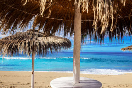 Sunshade on the beach near the blue oceanの写真素材