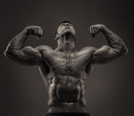 Bodybuilder male posing showing his huge musculesの写真素材