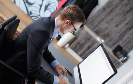 Handsome young business man working with computer in office.の写真素材