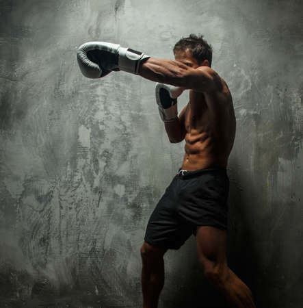 Awesome male with great body antomy boxing. Grey background.の写真素材
