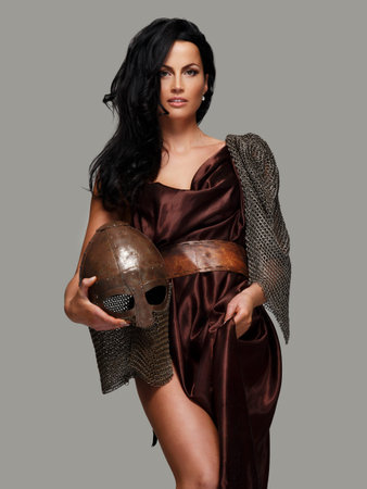 Awesome female with ancient weapon. Isolated on grey.の写真素材