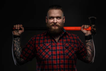 Portrait of the man with beard in red shirt and leopard bow tie. Isolated on dark gray backgroundの写真素材