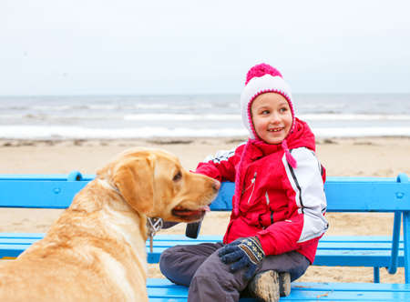 The dog protect little girl.の写真素材