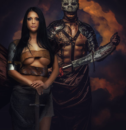 Male and female in ancient armor with swords