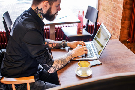 Man working with laptop in cafe