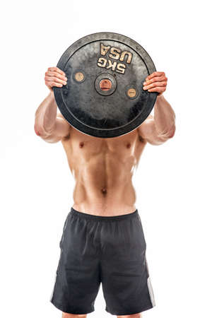Young bodybuilder holding weights. Isolated on whiteの写真素材