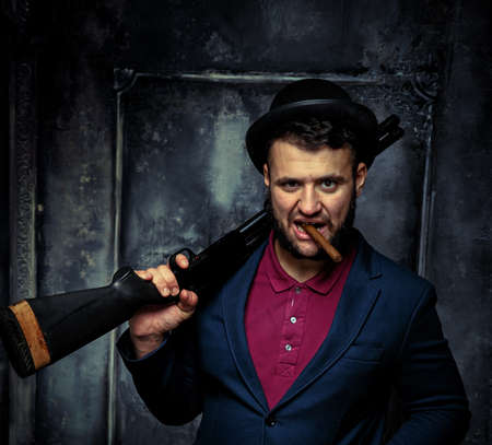 Jewish gansgter smoking a cig.Against art-wall on the backgroundの写真素材