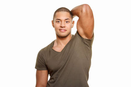 Attractive smiling muscular guy in green shirt. Isolated on whiteの写真素材