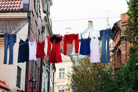 Colorful drying clothes on the old town streetの写真素材