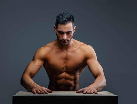 Shirtless muscular guy on grey backgroundの写真素材