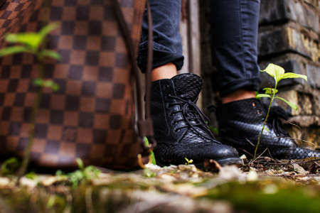 Brown fashionable bag and womans black bootsの写真素材