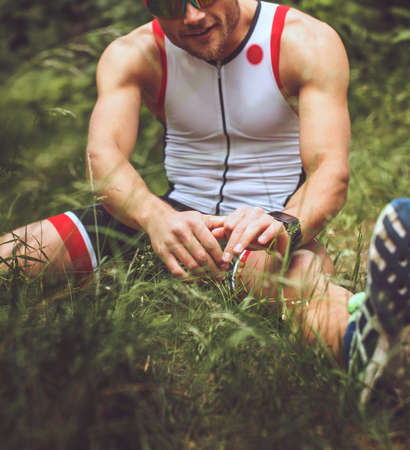 Male in sportswear doing body extension in the forest.の写真素材