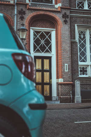 Part of blue car and antique door on background.の写真素材