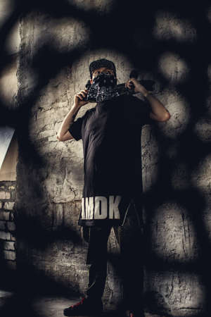 Brutal guy in face mask posing on camera.