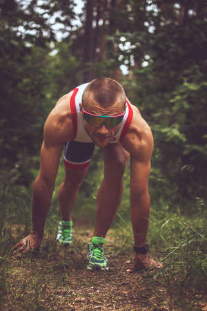 Sportsman running in the forest.の写真素材