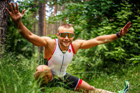 Fitness man doing exercises on nature.