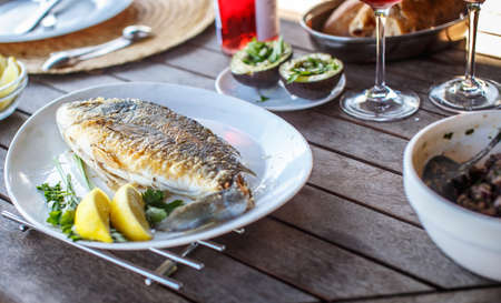 Fish food on white plate with lemon.の写真素材