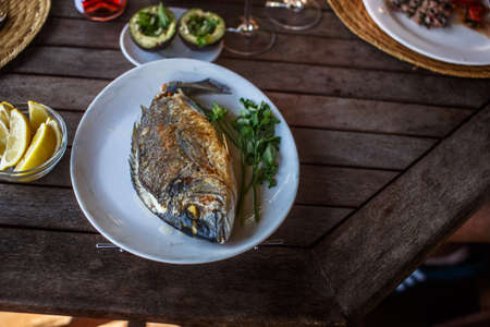 Fish food on white plate with lemon.の写真素材
