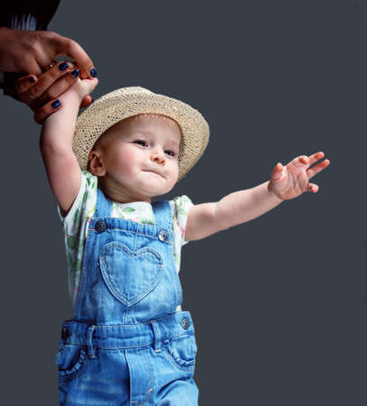 Cute little child in jeans costume and summer hat.の写真素材