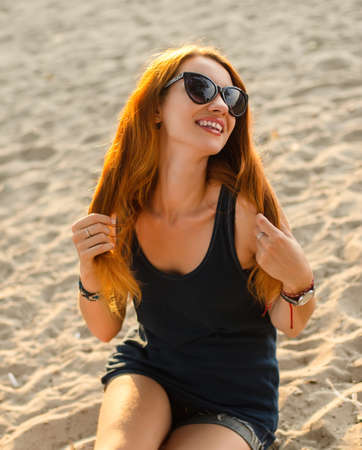 Portrait of redhead woman on a beach.の写真素材