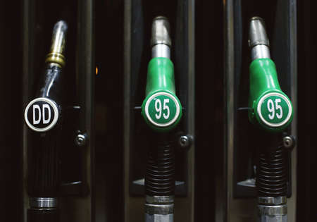 Green fuel pistols on fuel station.の写真素材