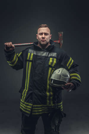 Picture of firefighter in uniform over grey background.の写真素材
