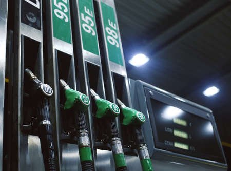 Green fuel pistols on fuel station.の写真素材