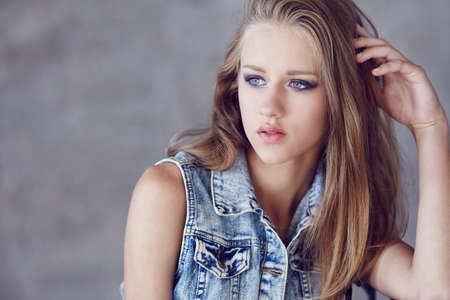Portrait of blond young woman with blue eyes.の写真素材