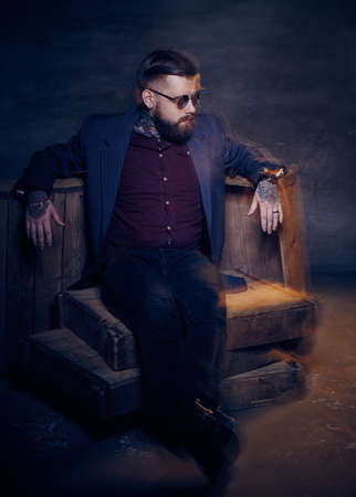 Glamorous bearded man in sunglasses posing in studio.の写真素材