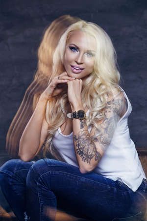 Gorgeous blond woman posing in studio.の写真素材